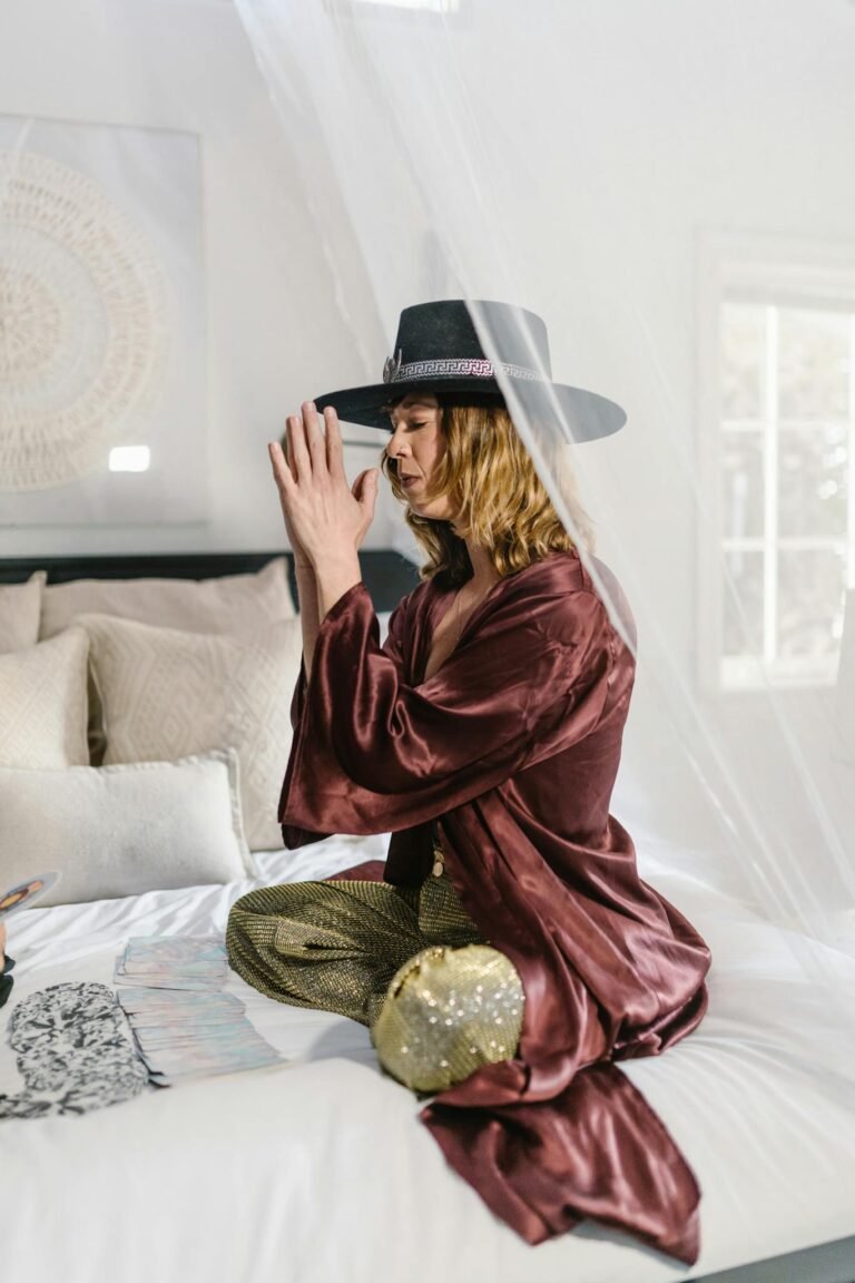 Woman in Red Robe Sitting on Bed